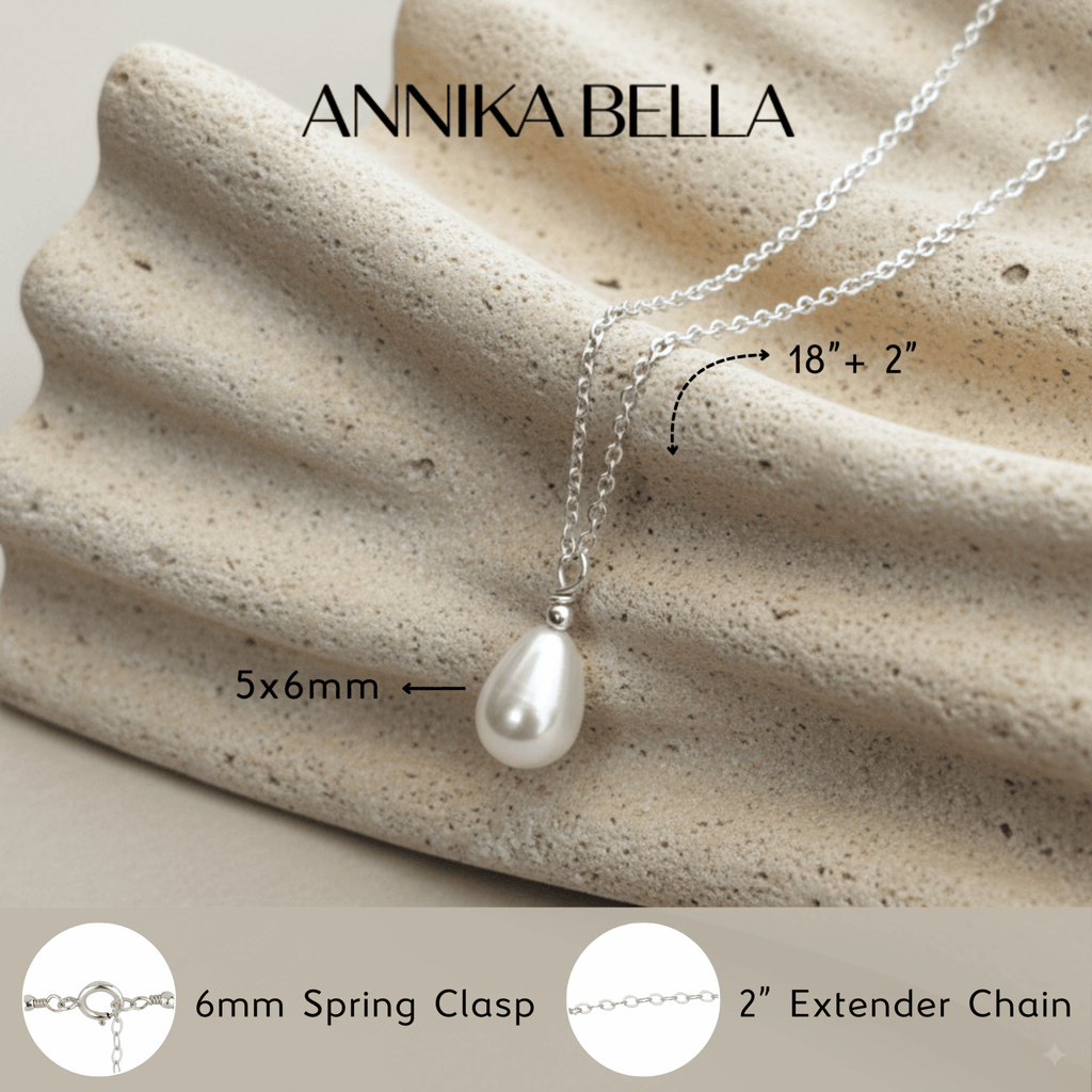 Freshwater Pearl necklace with a silver chain on a textured beige surface, featuring the brand name 'ANNIKA BELLA'.