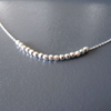 silver beads necklace set on a grey background