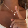women wearing a necklace made with a dainty sterling silver chain and a freswater round pearl 