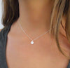 medallion charm necklace on a woman 