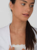 model with a white blazer and silver neck piece 