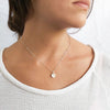 A silver necklace styled on its own and sparkles bright 