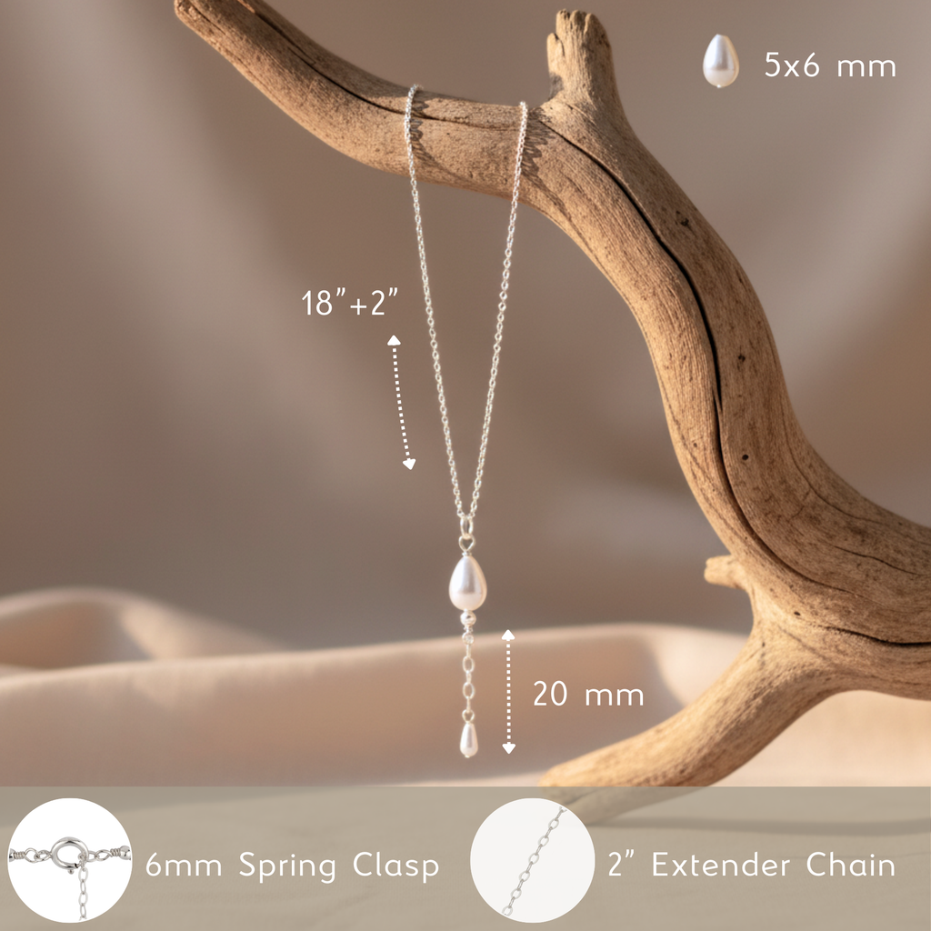 Necklace with pearl pendant on a tree branch, showing measurements and clasp details.
