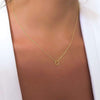 Model wearing a Gold Necklace with a Tiny  textured Circle charm.